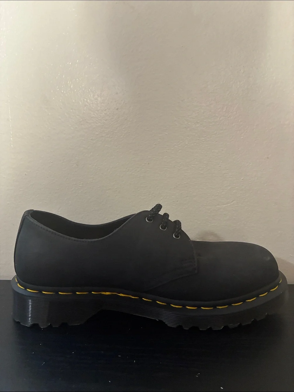 Dr. Martens 1461 leather oxfords feature the brand's signature yellow size 8
